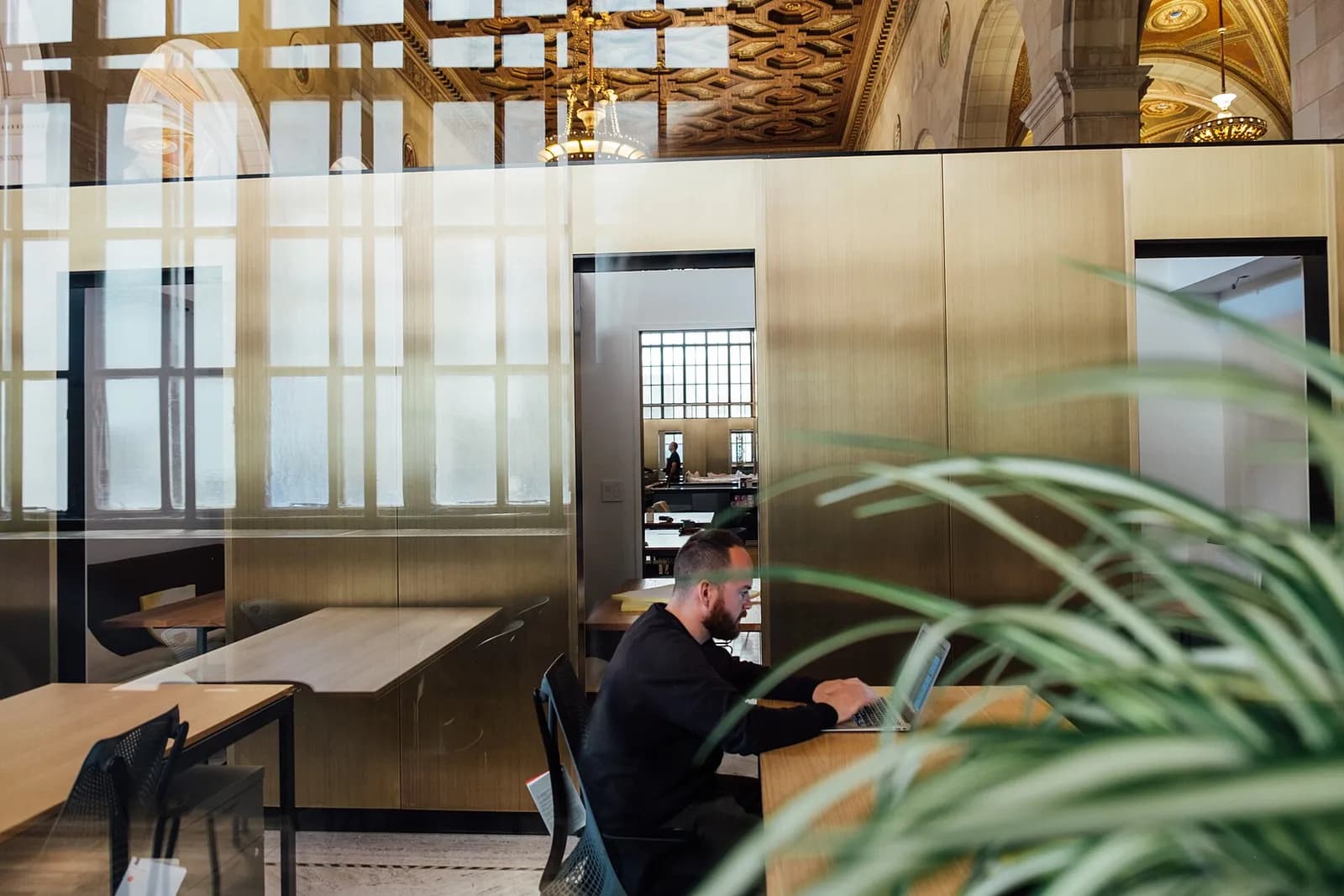 Bright modern coworking office with glass meeting rooms